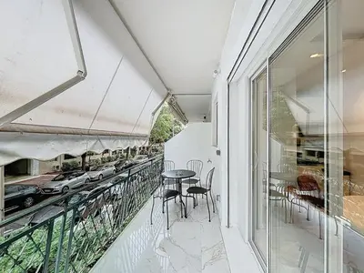 a white kitchen with a stove and a microwave at Executive 2BR Apartment near Croisette Ideal for MIPIM Terrace & Wi-Fi in Cannes