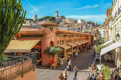 a group of people walking down a street in a city at Ideal for MIPIM Compact Executive Apartment Walk to Palais Suquet in Cannes