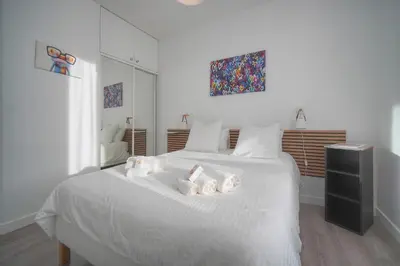a bedroom with a white bed with towels on it at Lumineux 2 Chambres-BALCON-Stanislas Chic A2B264 in Cannes