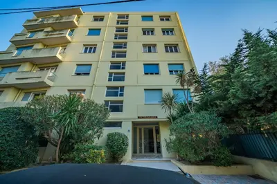 a tall yellow building with trees in front of it at Top floor 3 Bedroom near the Croisette in Cannes
