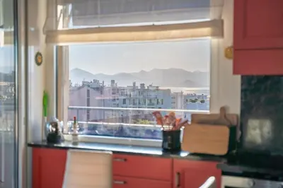 a kitchen with a window with a view of a city at Top floor 3 Bedroom near the Croisette in Cannes