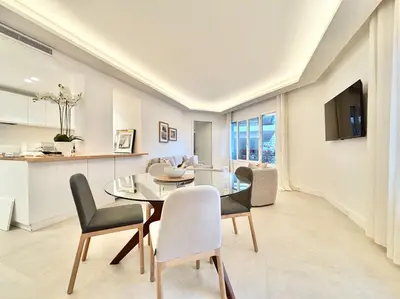 a dining room and kitchen with a glass table and chairs at Cannes 2x2 bedrooms apartment - 24P3 in Cannes
