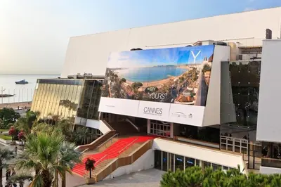a building with a large billboard on the side of it at Au coeur du vieux Cannes - 2 pièces - 4 couchages - 500 m du Palais des Festivals in Cannes