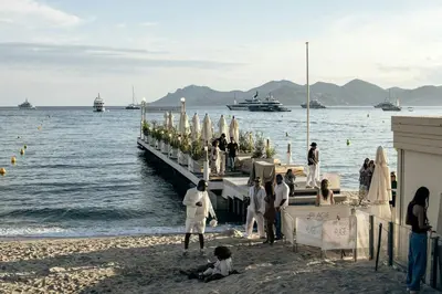 a group of people standing on a dock on the beach at Charme au Suquet 1 Chambre & Canapé-Lit AC in Cannes