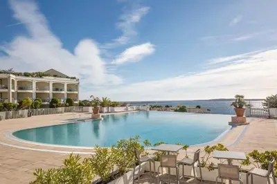 a swimming pool with chairs and a building at Cannes, garden level, pool, nearby beaches in Cannes
