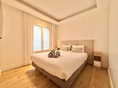 a bedroom with a large bed with shoes on it at Cannes - 2 bedrooms & 2 bathrooms apartment - 24P1 in Cannes