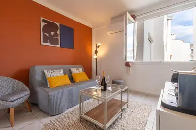 a living room with a couch and a table at My Studio in Center of Cannes in Cannes