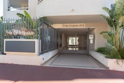 an entrance to a building with a sign on it at 2P Palm Beach parking, clim et jardin in Cannes