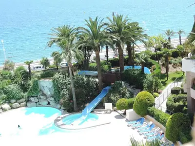 a pool with a water slide at a resort at Cannes Front Beach Pools Apartment in Cannes