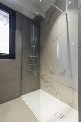 a shower with a glass door in a bathroom at Résidence Vue Mer Cannes in Cannes