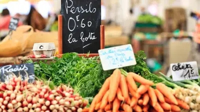 a vegetable stand with carrots and other vegetables on display at Antares POP in Cannes