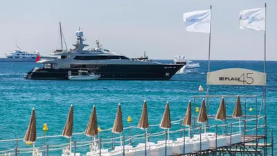 a large boat in the water with a bunch of umbrellas at Velapop in Cannes