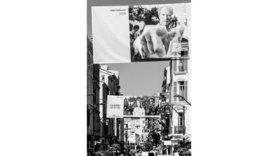 a black and white photo of a street with buildings at Lemoine in Cannes