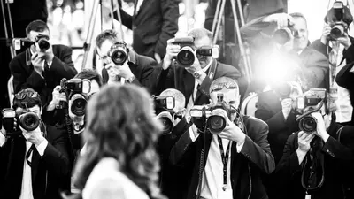 a group of people taking pictures with cameras at Lemoine in Cannes