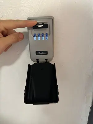 a person holding a electronic device on a wall at Safari apartment in heart of Cannes and beaches in Cannes