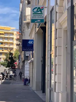 a sign on the side of a building on a street at ZEN 2 pièces 3 étoiles, plein centre cannes, à 5mn des plages et du palais in Cannes