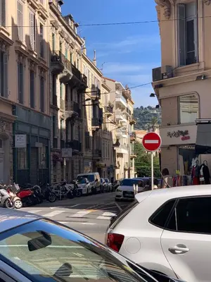 a street with cars parked on the side of the road at Cocooning 3 pièces duplex 3 étoiles calme centre ville à 5mn plages et Palais in Cannes