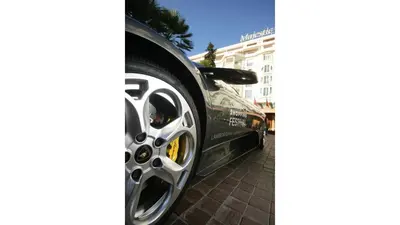 a black car is parked on a brick sidewalk at Jonquille in Cannes