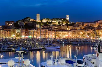 a harbor with boats in the water at night at Appartement duplex 6 personnes Cannes Grand Parc in Cannes