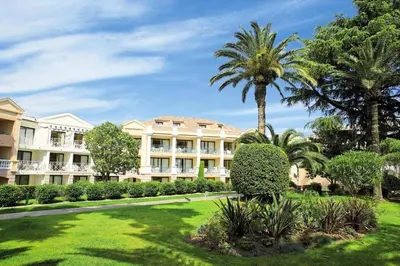a large building with palm trees and a lawn at Résidence Cannes Villa Francia - maeva Home - Appartement 2 pièces 4 personnes - Confort MAE-1762 in Cannes