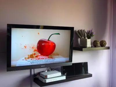 a television with a red apple on the screen at Cannes Center in Cannes