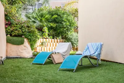 two lawn chairs sitting on the grass in a yard at Palm Beach - swimming pool - beach at few steps in Cannes