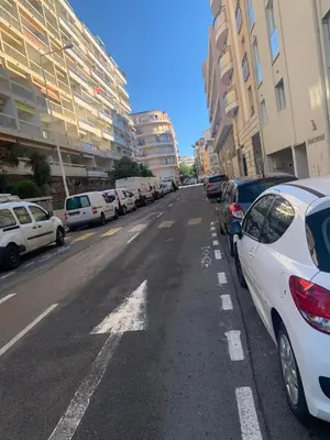 a street with cars parked on the side of the road at Branly 3, by Welcome to Cannes in Cannes