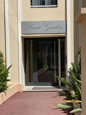 an entrance to a building with a sign on it at Apartment Palm Beach with a nice swimming pool in Cannes