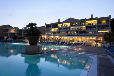 a large hotel with a swimming pool at night at Résidence Cannes Villa Francia - maeva Home - Appartement 2 Pièces 6 Personnes - Budget MAE-6123 in Cannes
