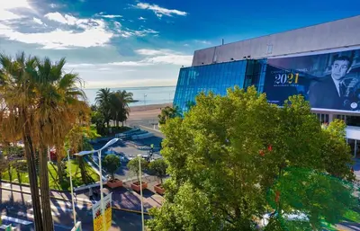 a building with a billboard on it next to a beach at Ref LEM4 - Palmes d'Or Properties in Cannes