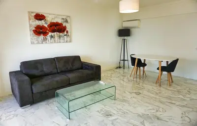 a living room with a couch and a table at Ref LEM4 - Palmes d'Or Properties in Cannes
