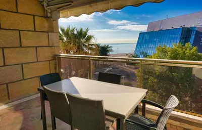 a table and chairs on a balcony with a view of the ocean at Ref LEM4 - Palmes d'Or Properties in Cannes