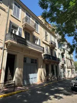 an apartment building with a garage on a city street at Red Calmette in Cannes