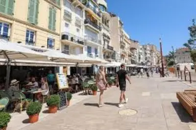 a man and a woman walking down a city street at 2 chambres BALCON, FELIX FAURE-COEUR DE CANNES A2B022 in Cannes