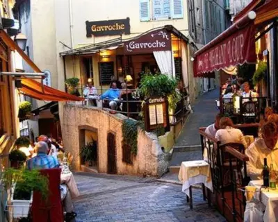 a group of people sitting at tables outside a restaurant at Bel appartement bien placé au cœur de Cannes in Cannes
