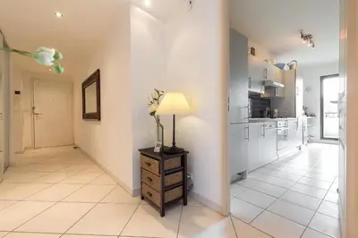 a living room with a lamp on a dresser at Cannes centre 2mins from beach stunning 3-Bed Apt in Cannes