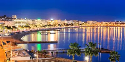 a view of a river with a city at night at Ideal congress and vacation LIVE IN VILLA PARADOR in Cannes
