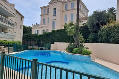 a swimming pool in front of a building at HENRI CAMILLE RE - Passy 2 -Beautiful one bedroom swimming pool and parking in Cannes