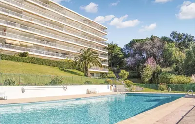 a swimming pool in front of a building at 1 Bedroom Gorgeous Apartment In Cannes in Cannes