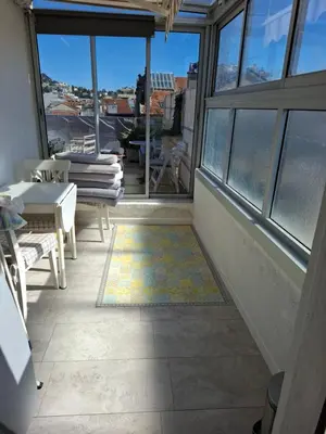 a balcony with a view of a room with windows at Macé9 in Cannes