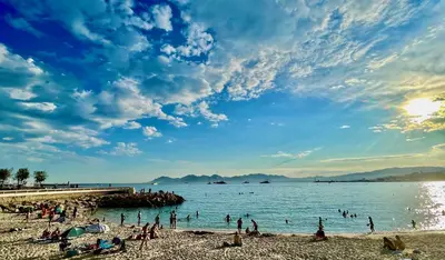 a group of people on a beach near the water at Townhouse in the heart of the suquet - 4 bedrooms in Cannes