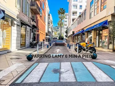 a street with a motorcycle parked in the middle at Confortable Studio Calme, Latour Mauboug-CARLTON MARTINEZ A0B107 in Cannes