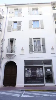 a white building with a door and a window at Proche Carlton & Croisette, Appartement 301 - Palmazur Vacances in Cannes