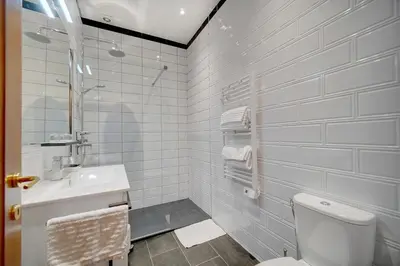 a white bathroom with a toilet and a sink at REF 1320 - Cannes Center - Apartment for rent in Cannes