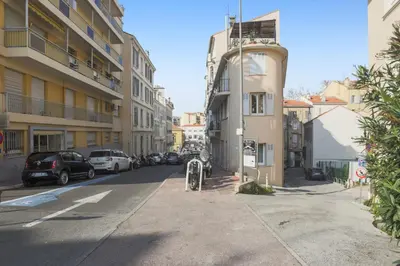 a street with cars parked on the side of a building at Studio Soleil - Welkeys in Cannes