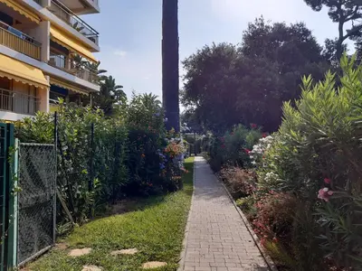 a path in a garden next to a building at Trident A in Cannes