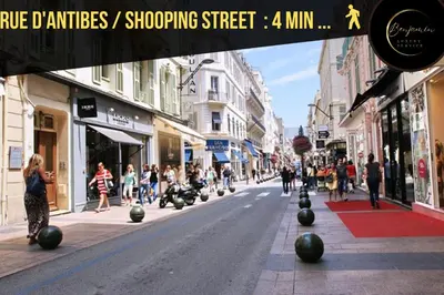a city street with people walking down the street at L'atelier des Artistes -Écrin de sérénité au coeur de Cannes - Balcon - Clim - Wifi in Cannes
