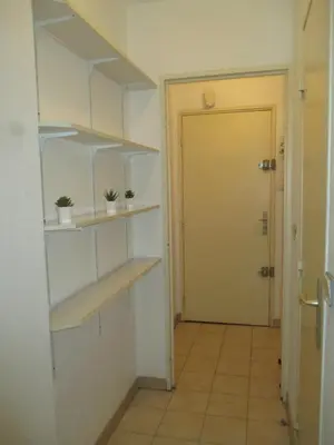 a hallway with shelves and a door to a room at Studio à 5 minutes à pied des plages et de la croisette in Cannes