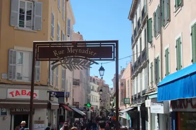 a street with a sign for arue montpellier in a city at Cannes Croisette Rue Meynadier Palais 1 mn Modern 1 BR by Olam Properties in Cannes