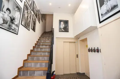 a hallway with stairs and pictures on the walls at IMMOGROOM - Bright and Cosy - SUQUET - next to the beaches - AC in Cannes